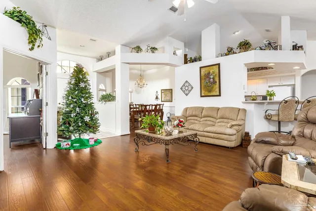 a view of a house with pool and a yard