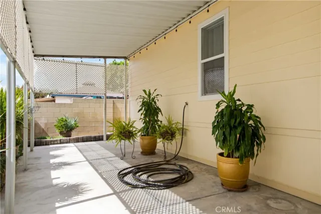 a vase of flowers sitting on a floor in front of a door