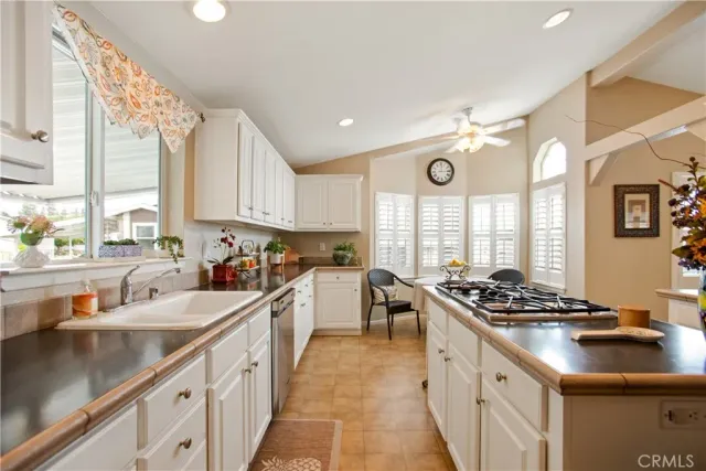 a kitchen with stainless steel appliances a sink a stove and a window
