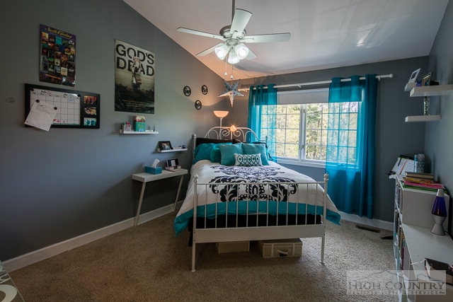 1762 Hidden Spring Road West Jefferson, NC 28694 - Photo 19 of 46 a bed sitting in a bedroom next to a window