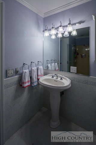 1762 Hidden Spring Road West Jefferson, NC 28694 - Photo 21 of 46 a bathroom with a sink a mirror and a lamp