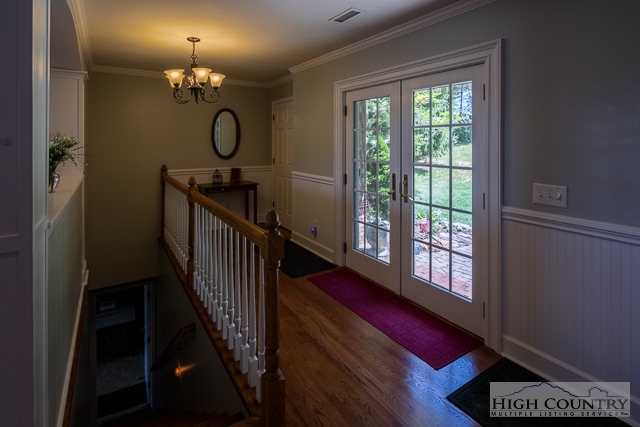 1762 Hidden Spring Road West Jefferson, NC 28694 - Photo 22 of 46 a view of a hallway with windows and chandelier