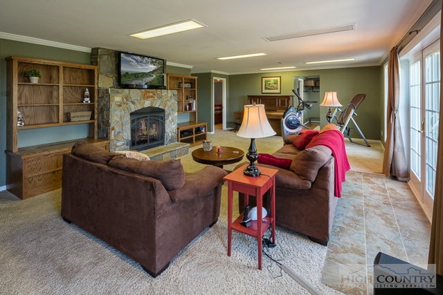1762 Hidden Spring Road West Jefferson, NC 28694 - Photo 23 of 46 a living room with furniture a flat screen tv and a fireplace