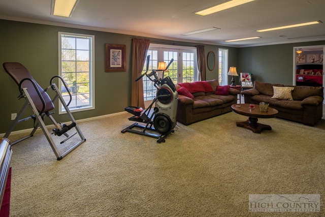 1762 Hidden Spring Road West Jefferson, NC 28694 - Photo 25 of 46 a living room with furniture a window and gym equipment