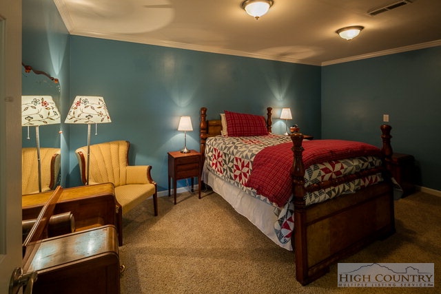 1762 Hidden Spring Road West Jefferson, NC 28694 - Photo 28 of 46 a bedroom with a bed and a couch