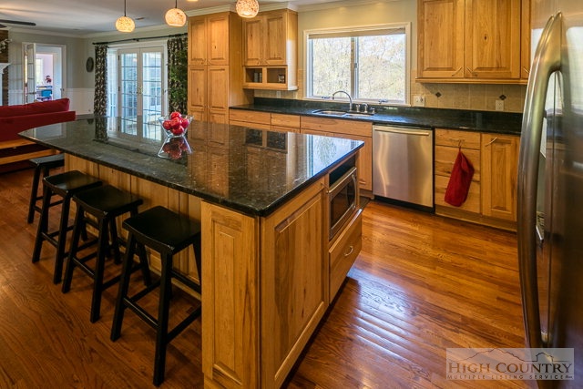 1762 Hidden Spring Road West Jefferson, NC 28694 - Photo 3 of 46 a kitchen with stainless steel appliances granite countertop sink stove and cabinets