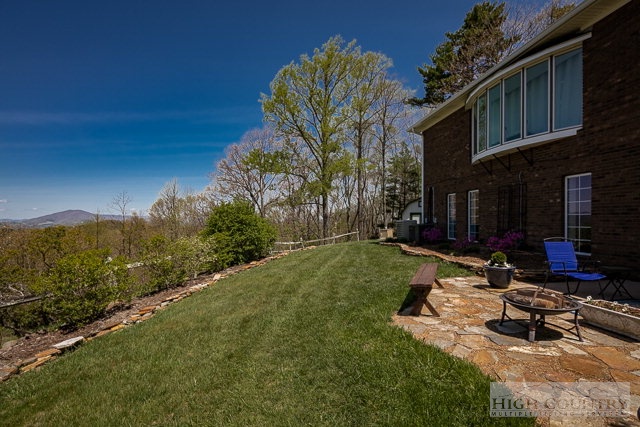 1762 Hidden Spring Road West Jefferson, NC 28694 - Photo 33 of 46 a view of a backyard with plants and a patio
