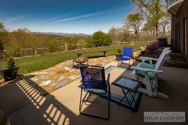 1762 Hidden Spring Road West Jefferson, NC 28694 - Photo 34 of 46 a view of a patio with table and chairs with wooden floor and fence
