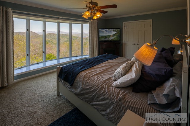 1762 Hidden Spring Road West Jefferson, NC 28694 - Photo 4 of 46 a bedroom with a bed and a chandelier