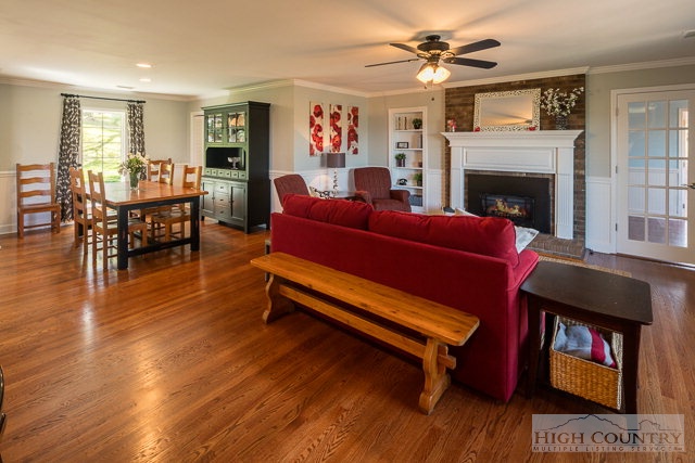 1762 Hidden Spring Road West Jefferson, NC 28694 - Photo 44 of 46 a living room with furniture a fireplace and a flat screen tv