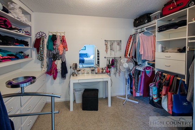 1762 Hidden Spring Road West Jefferson, NC 28694 - Photo 9 of 46 a view of walk in closet with clothes and shoes