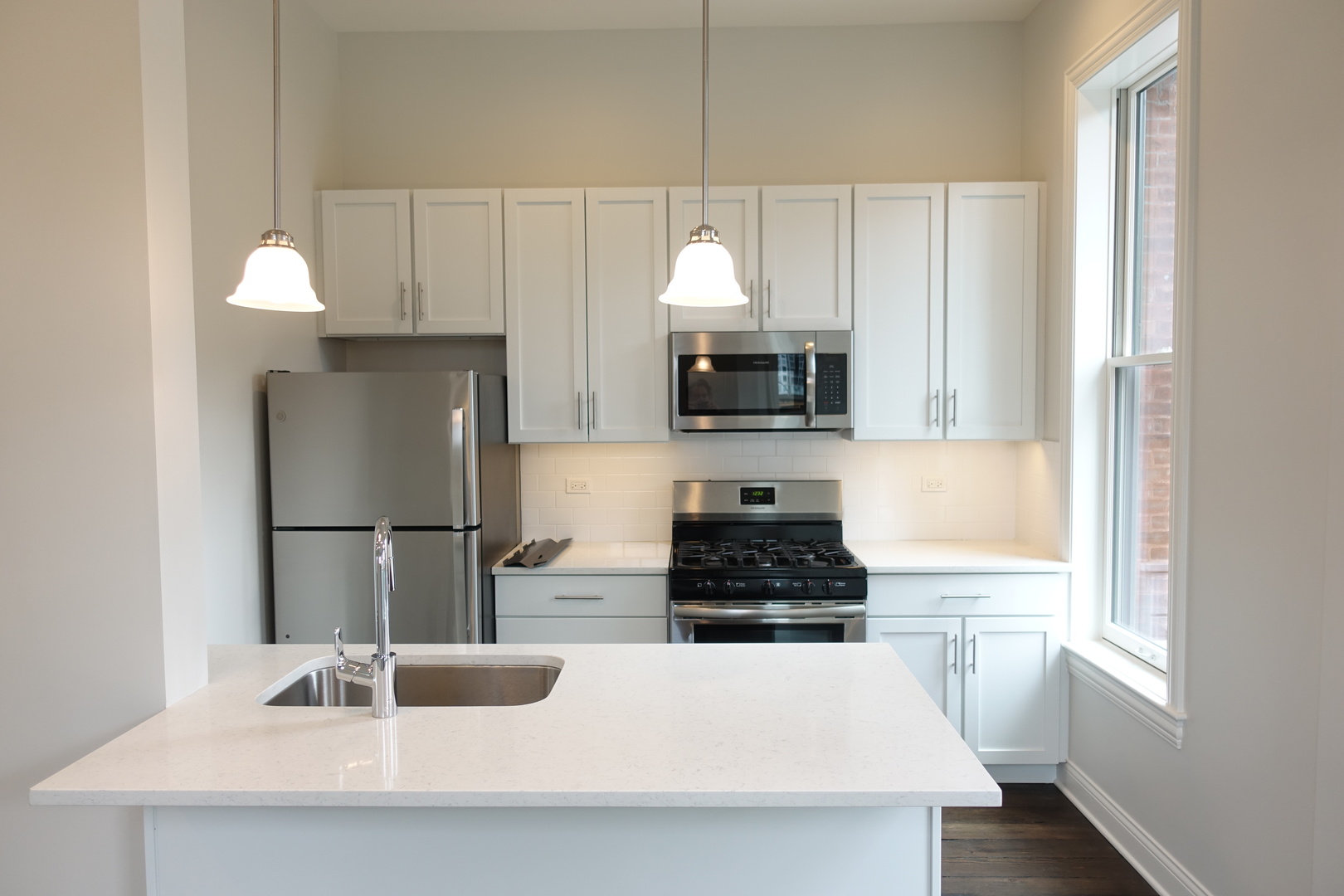 809 North Franklin Street, Unit 2F Chicago, IL 60610 - Photo 3 of 14 a kitchen with a sink a stove and refrigerator