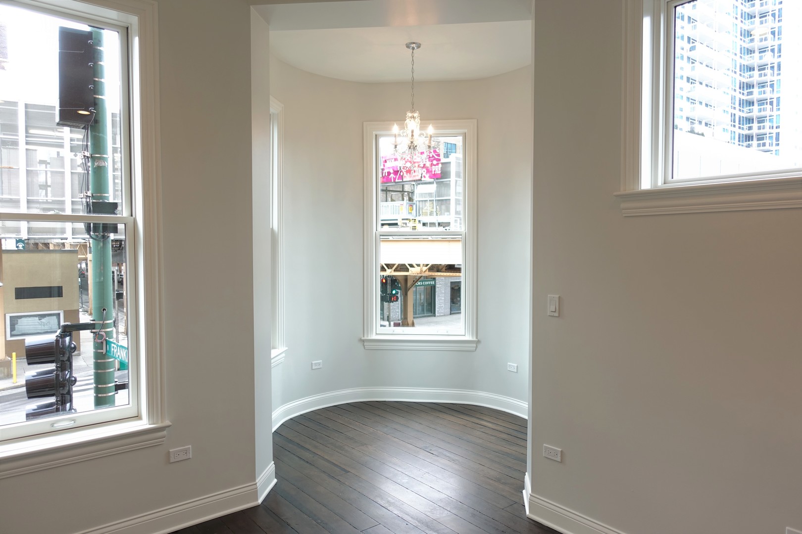 809 North Franklin Street, Unit 2F Chicago, IL 60610 - Photo 7 of 14 an empty room with wooden floor and windows