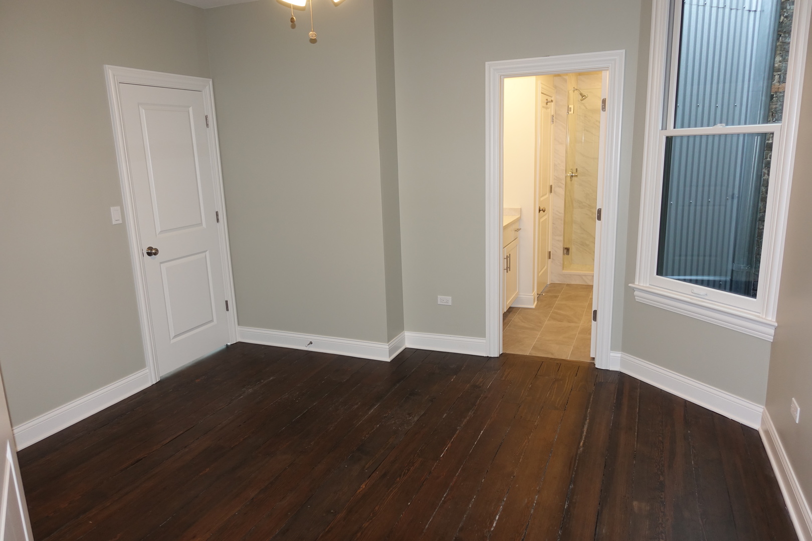 809 North Franklin Street, Unit 2F Chicago, IL 60610 - Photo 10 of 14 a view of an empty room with wooden floor and a window