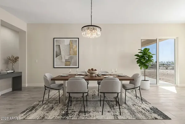 a dining room with furniture a rug and a chandelier
