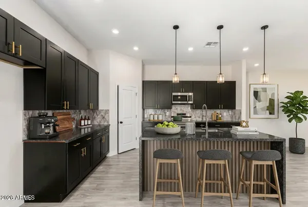 a kitchen with counter top space appliances and cabinets