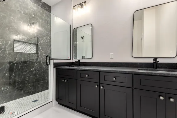a bathroom with a double vanity sink and a mirror