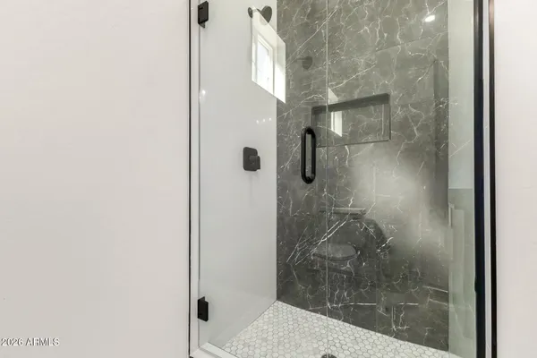 a bathroom with a glass shower door