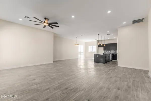 a view of a kitchen with furniture and a ceiling fan