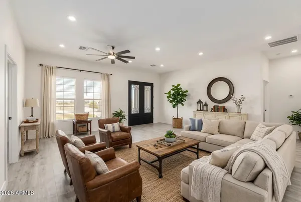 a living room with furniture potted plant and a chandelier