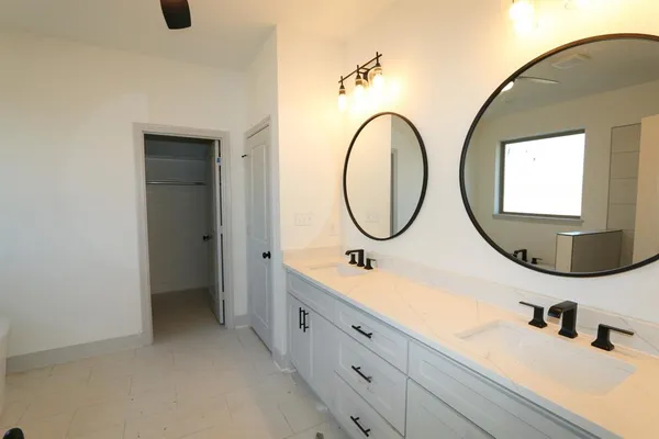 a bathroom with a double vanity sink double and mirror