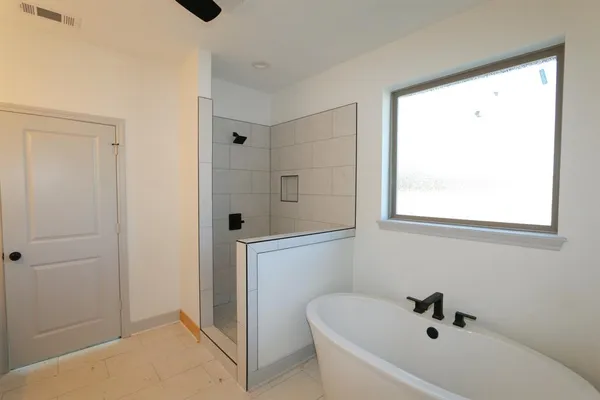 a bathroom with a bathtub and shower