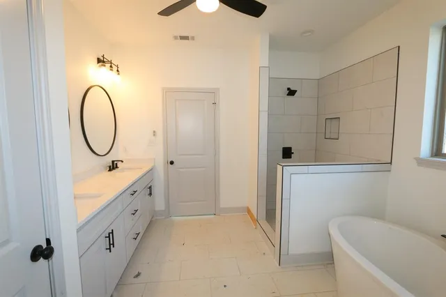 a bathroom with a tub a toilet and a sink