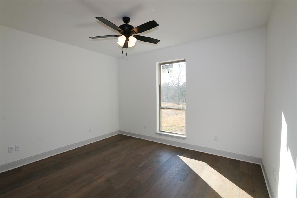 16527 Cooper Way Flint, TX 75762 - Photo 20 of 28 an empty room with wooden floor fan and windows