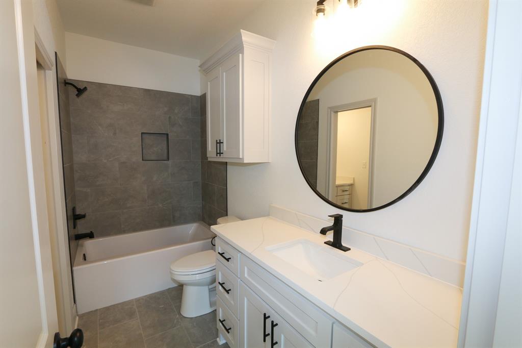 16527 Cooper Way Flint, TX 75762 - Photo 21 of 28 a bathroom with a sink a toilet and a mirror