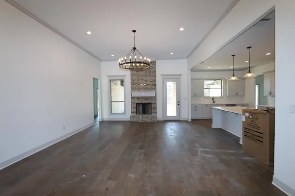 an empty room with a fireplace and window