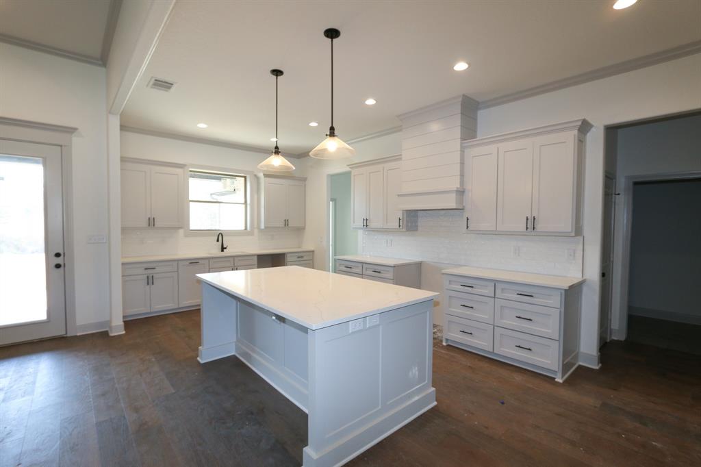16527 Cooper Way Flint, TX 75762 - Photo 5 of 28 a large kitchen with kitchen island a sink dishwasher a stove a refrigerator and white cabinets with wooden floor