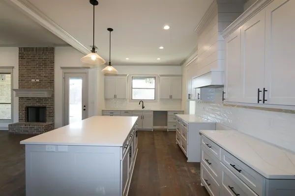 a kitchen with a stove a sink and a refrigerator