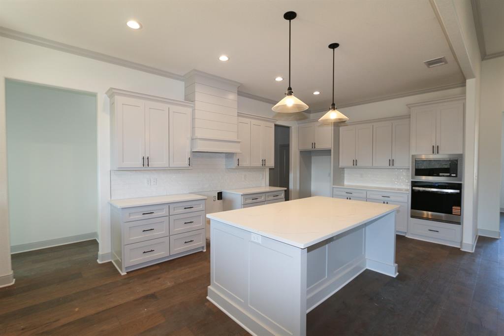 16527 Cooper Way Flint, TX 75762 - Photo 8 of 28 a large kitchen with kitchen island a stove a sink a center island and wooden floor