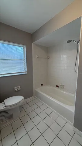 a bathroom with a toilet a sink and bathtub