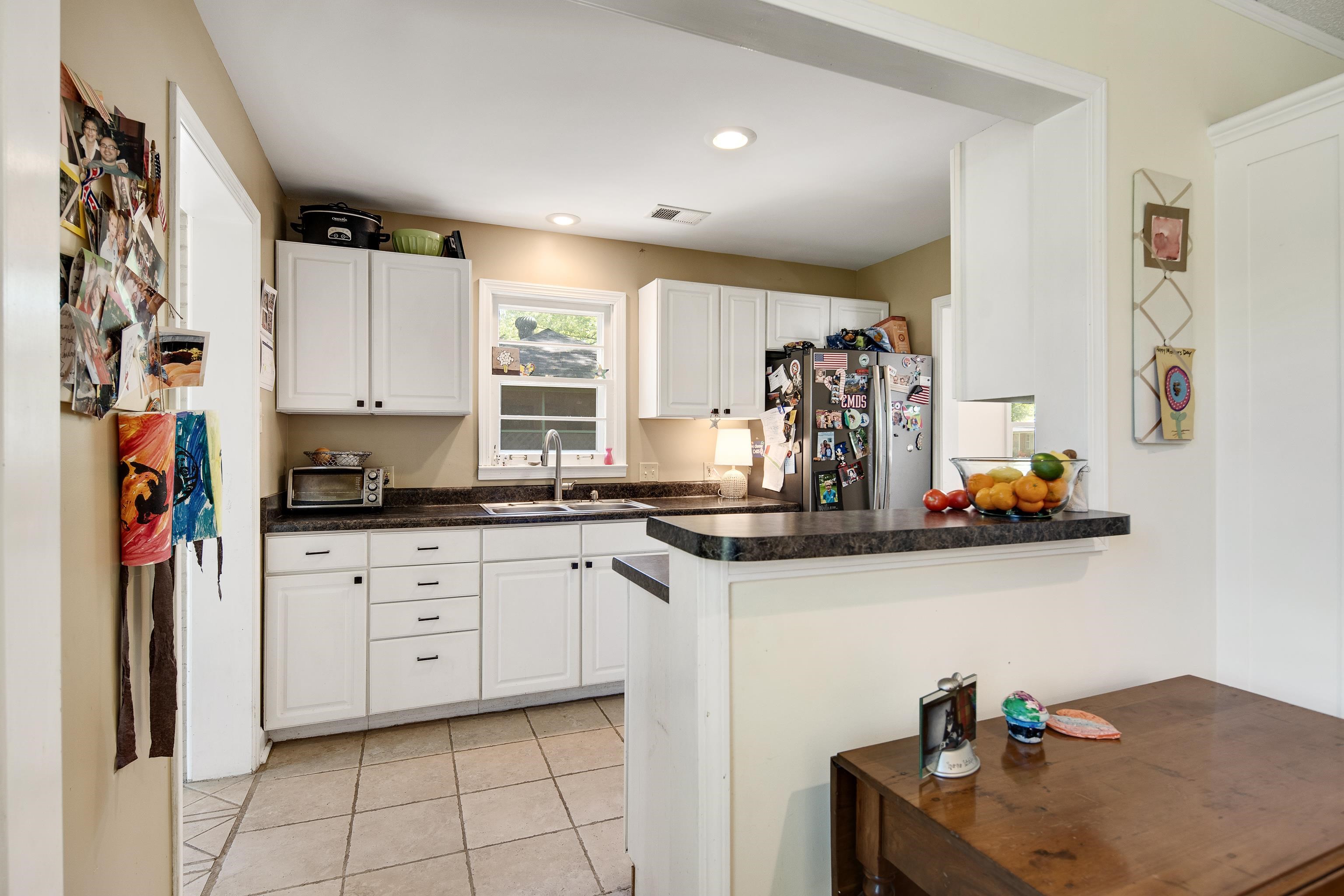 4566 Amboy Road Memphis, TN 38117 - Photo 13 of 29 a kitchen with stainless steel appliances granite countertop a sink and a refrigerator