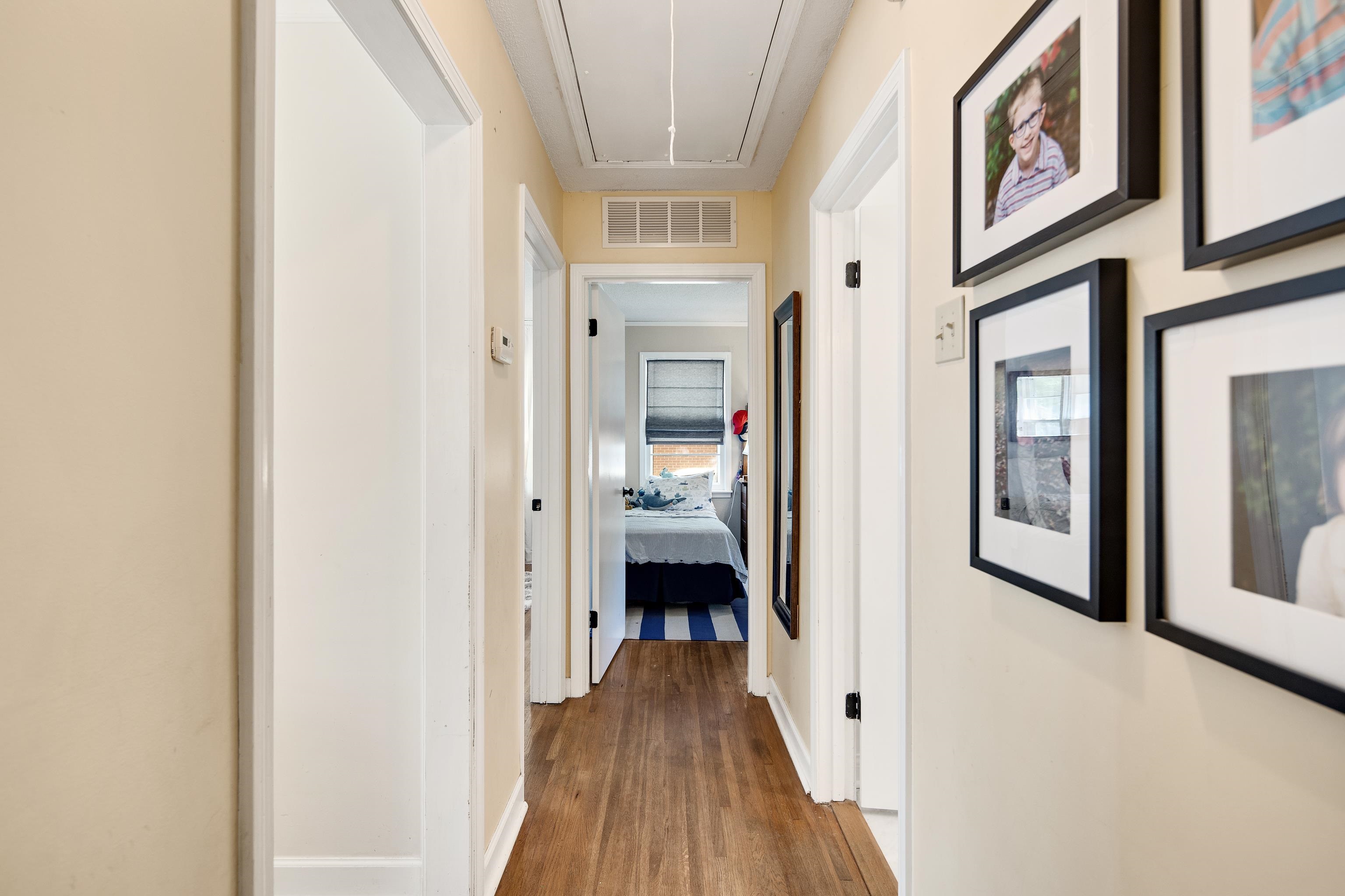 4566 Amboy Road Memphis, TN 38117 - Photo 18 of 29 a view of a hallway with wooden floor and a bathroom