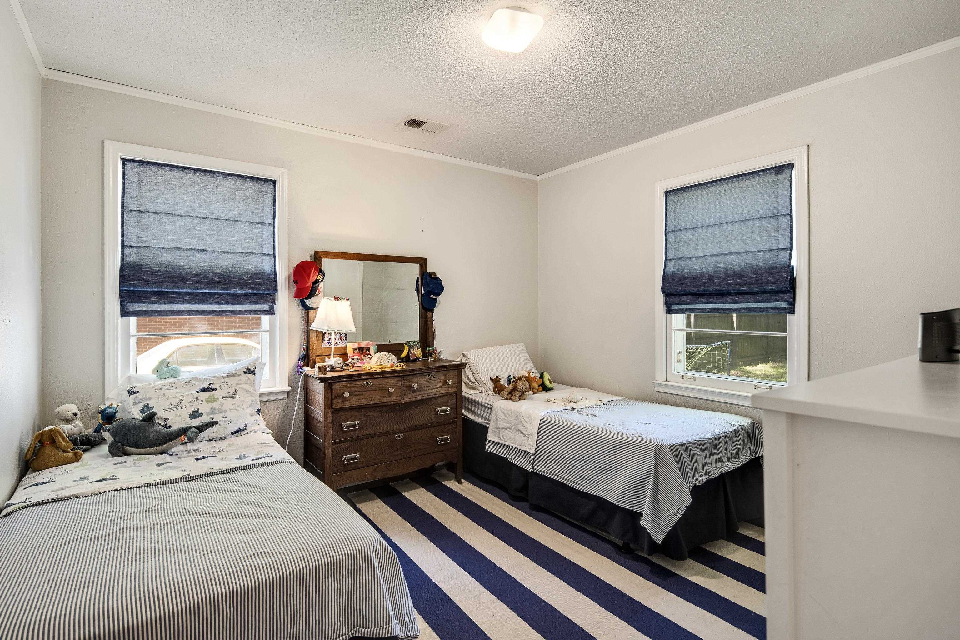 4566 Amboy Road Memphis, TN 38117 - Photo 22 of 29 a bedroom with a bed and wooden floor