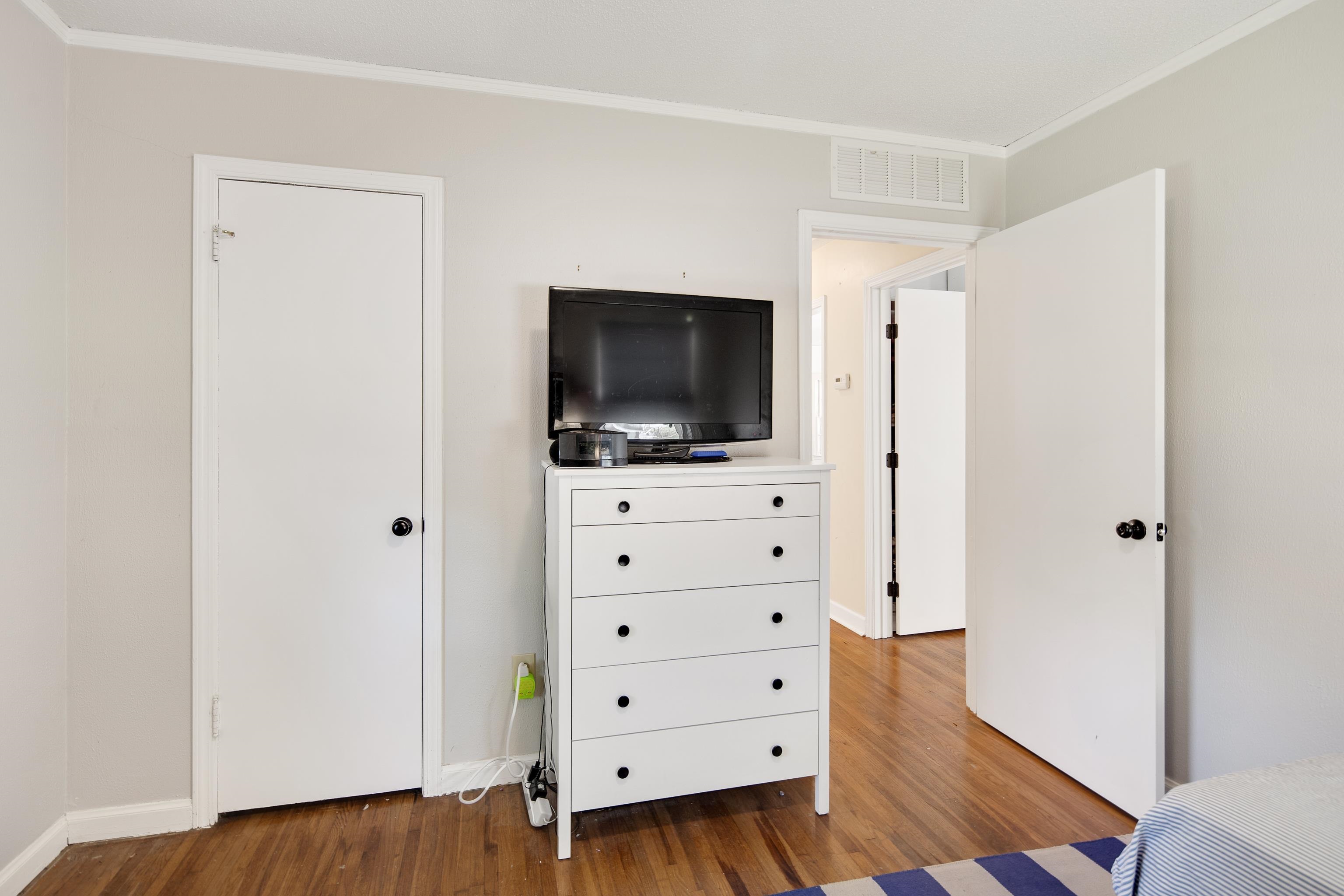 4566 Amboy Road Memphis, TN 38117 - Photo 23 of 29 a living room with flat screen tv dressers and a dresser