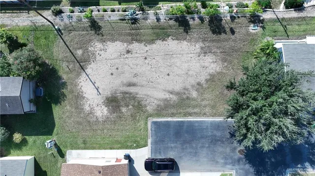 an aerial view of a house with yard and lake view