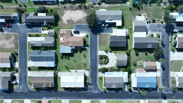 an aerial view of houses with yard