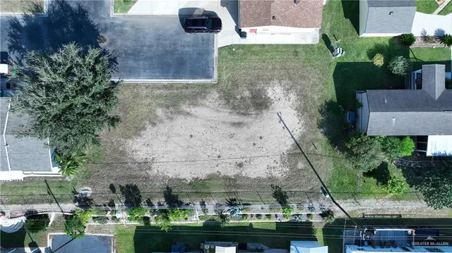 an aerial view of a house with a yard and lake view