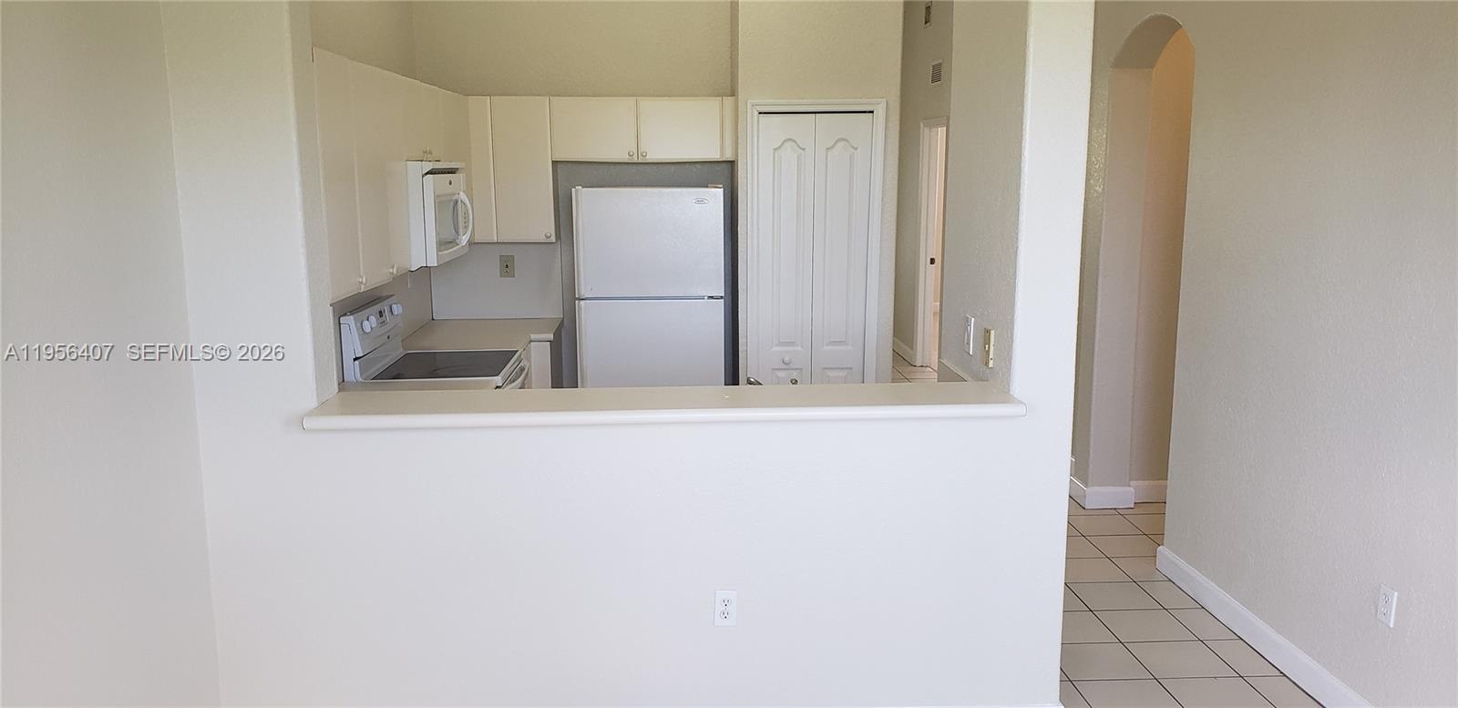 2811 Southeast 17th Avenue, Unit 202 Homestead, FL 33035 - Photo 17 of 71 a view of kitchen with cabinets and refrigerator