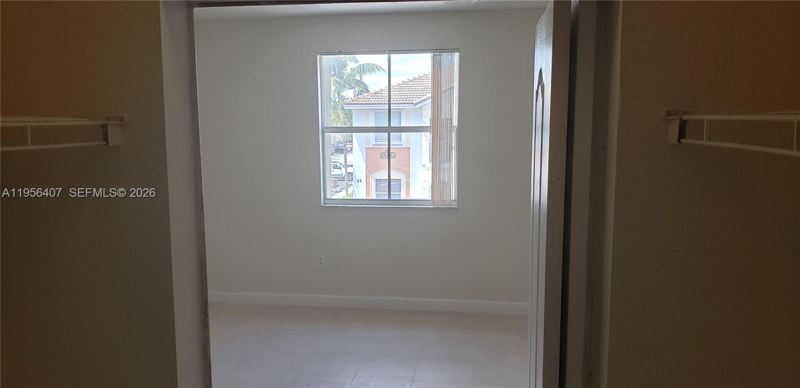 2811 Southeast 17th Avenue, Unit 202 Homestead, FL 33035 - Photo 61 of 71 a view of an empty room with a window