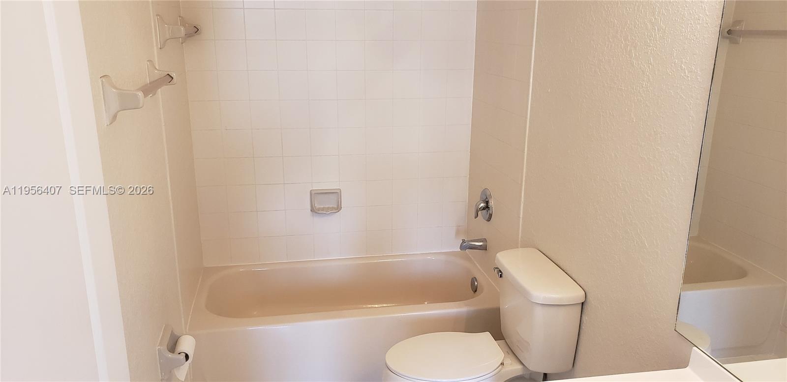 2811 Southeast 17th Avenue, Unit 202 Homestead, FL 33035 - Photo 63 of 71 a white bath tub sitting next to a white toilet