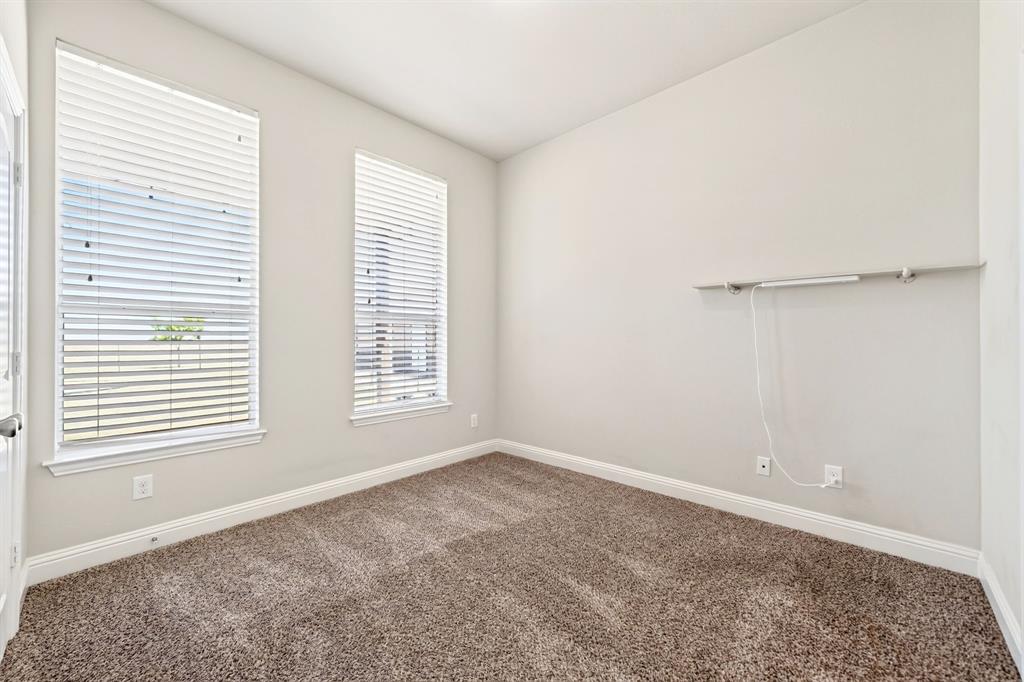 1836 County Road 5005 Blue Ridge, TX 75424 - Photo 14 of 28 Neutral wall paint, two windows with blinds, and carpeted flooring with ensuite full bathroom