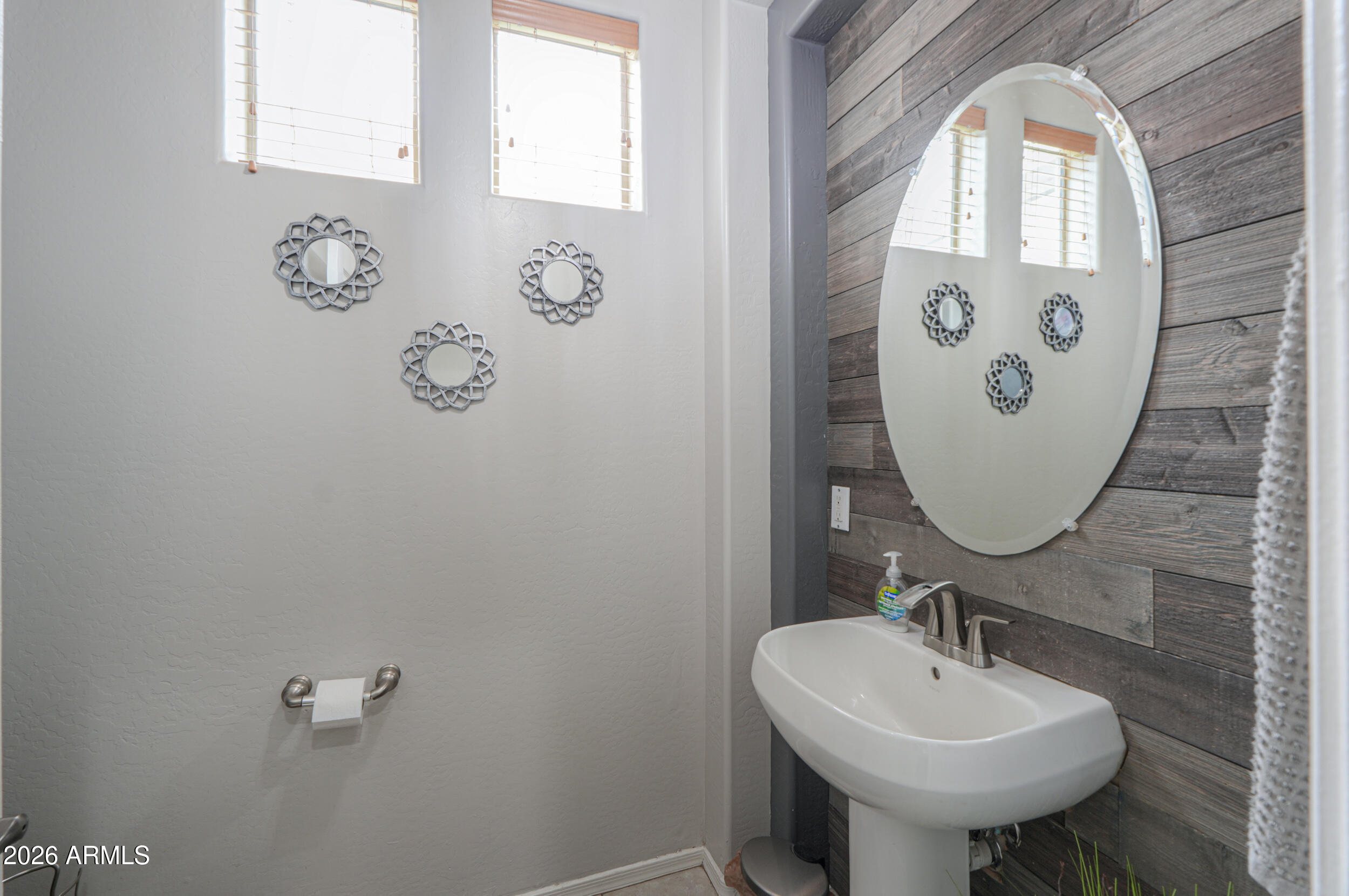 45247 West Jack Rabbit Trail Maricopa, AZ 85139 - Photo 27 of 75 a bathroom with a sink and mirror