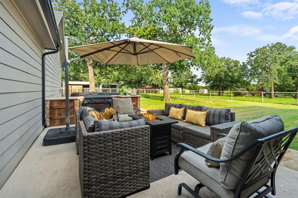 175 Porter Road Bartonville, TX 76226 - Photo 7 of 40 With views of the pasture and animals, the back patio is not only serene and peaceful but also the perfect place to gather, featuring an entertaining space with a built-in prep station for your grill—made for cookouts and star-lit conversations.