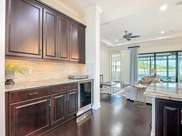 a living room with furniture a flat screen tv and a large window