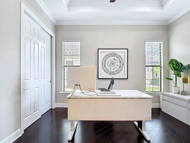 a room with pool table and windows