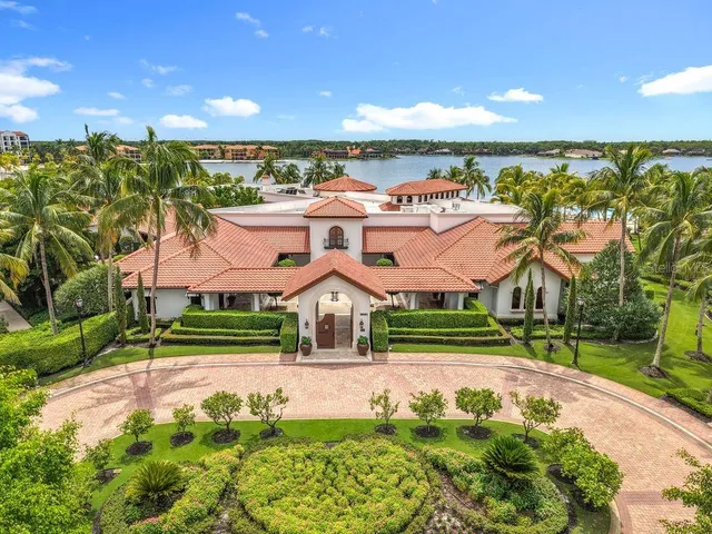 an aerial view of residential houses with outdoor space and swimming pool